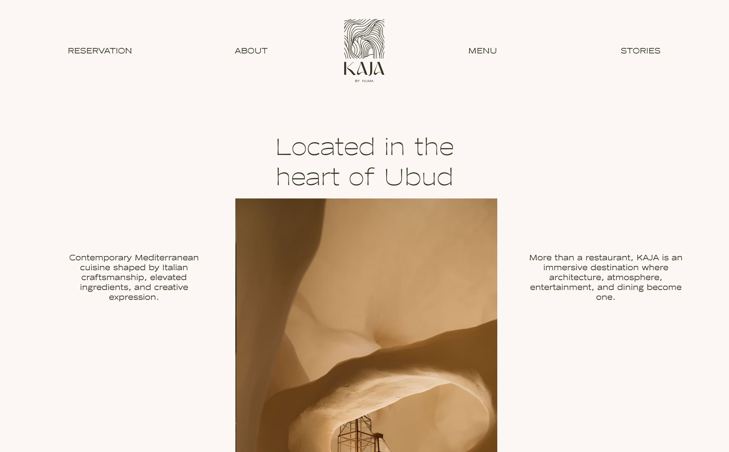 KAJA website home page: navigation around the centred logomark, the headline "Located in the heart of Ubud" and a photograph of the sculpted walls